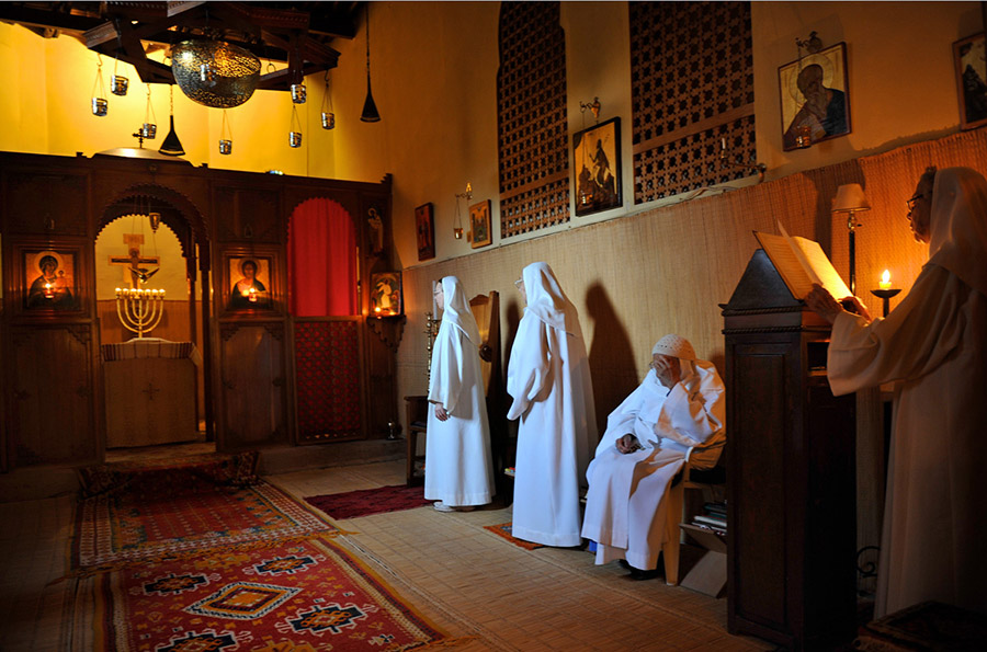 During vespers, the sisters of the oriental Catholic Monastery of the Visitation sing Psalms in both French and Arabic. A menohra casts a glow on the crucifix, Tazert, 2011