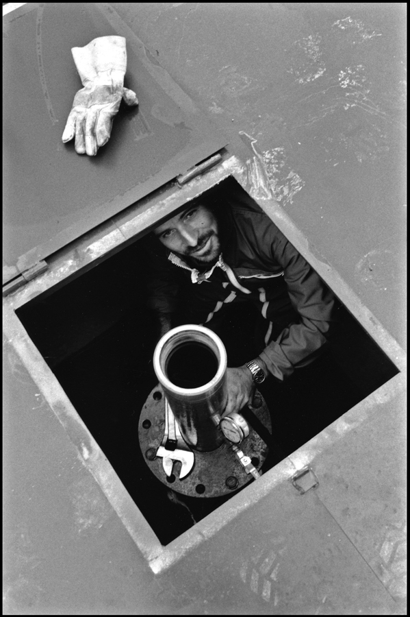 Engineer preparing scientific measurements in a borehole.