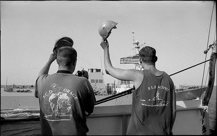 Two crewmen of the VAR salute the crew of destroyer USS Winston S. Churchill after supply