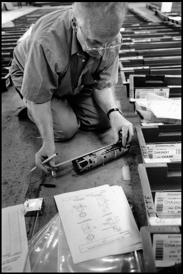 Geologist measuring a granite core sample.